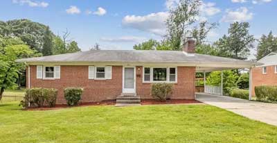 Light brick large home with carport